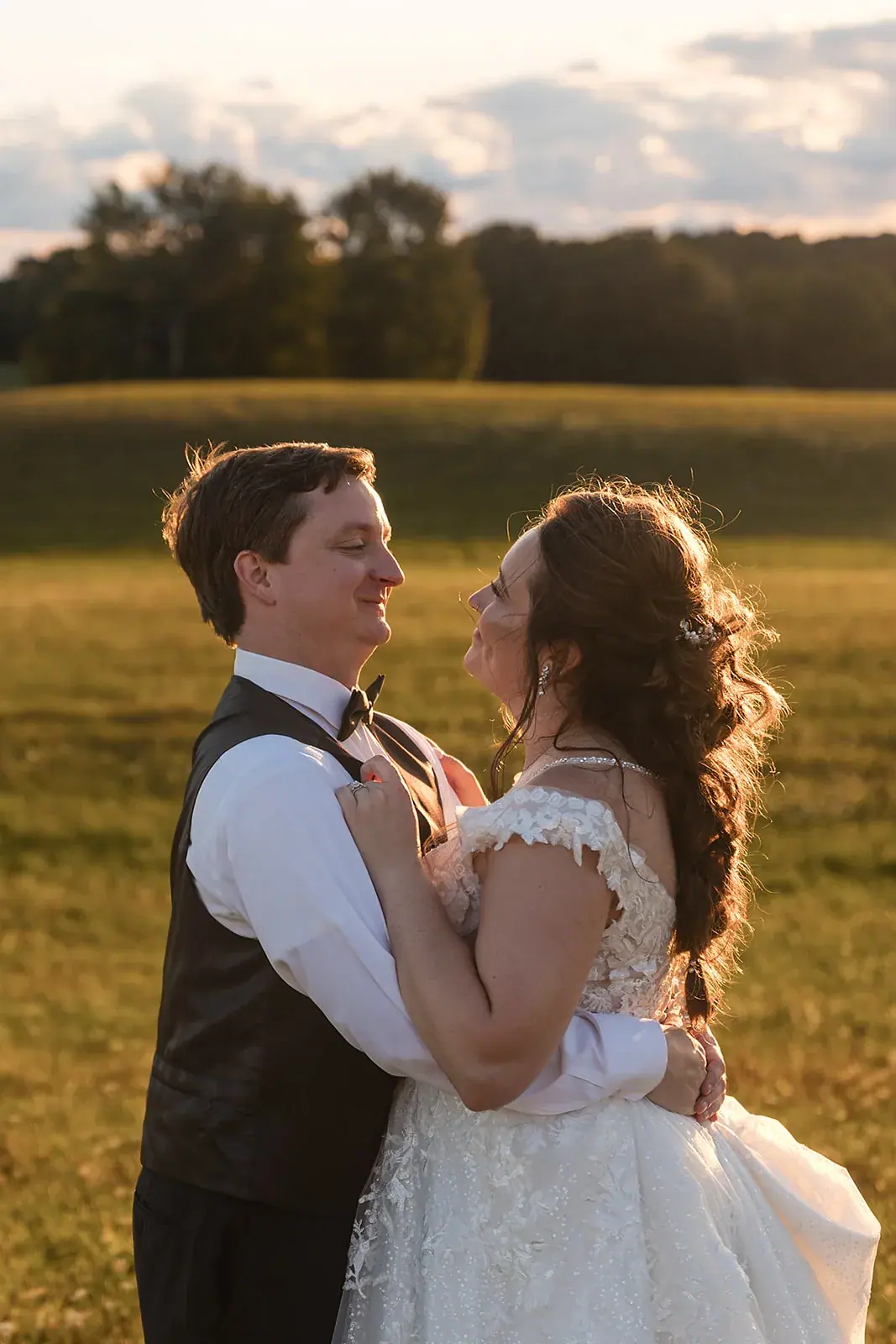 Couple dancing in a golden field at sunset