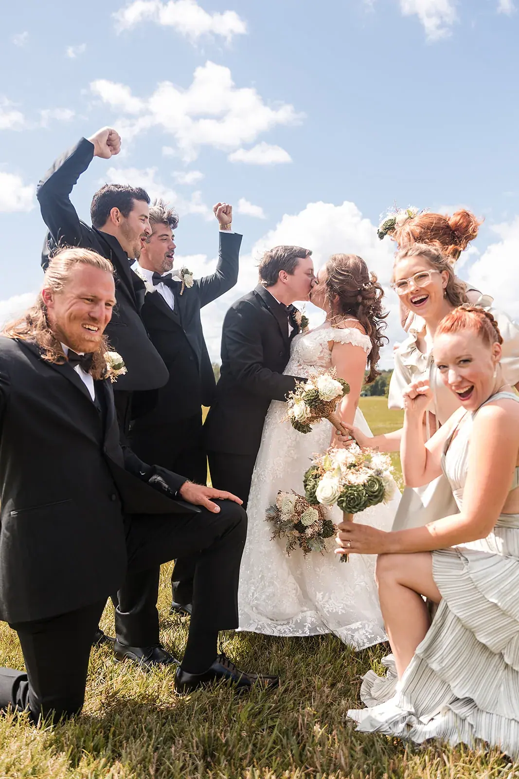 Full wedding party group celebrating