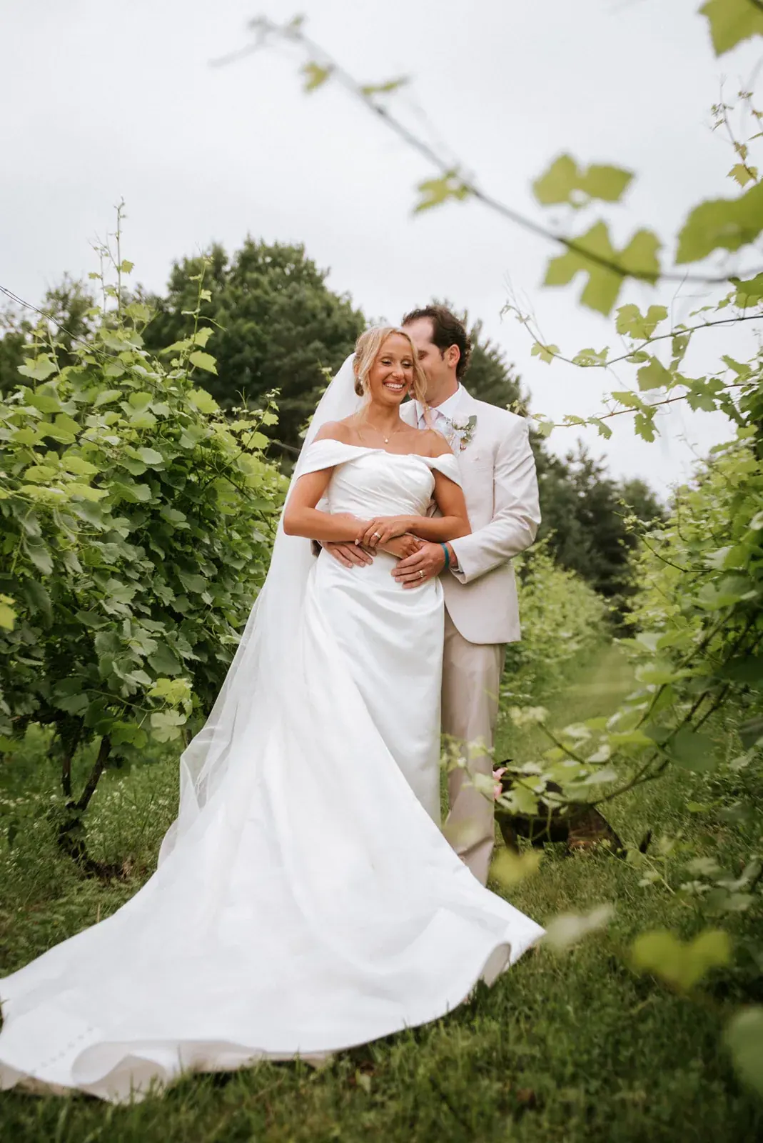Modern Cinema look: full-colour portrait of a bride and groom embracing in the vineyard at Black Star Farms