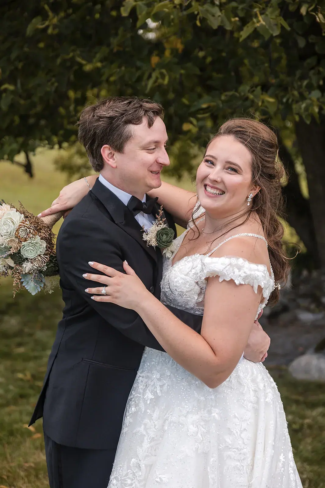 Bride and groom embrace portrait trees — Amelia & Howard's wedding at Sunset Hill Wedding Barn, Central Lake