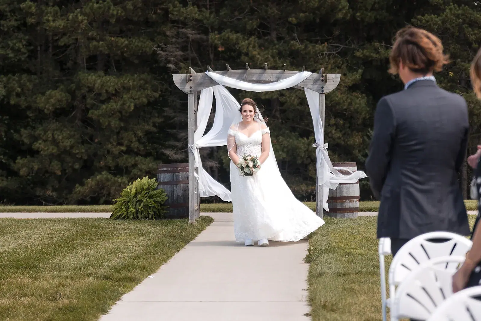 Bride walking down aisle pergola — Amelia & Howard's wedding at Sunset Hill Wedding Barn, Central Lake