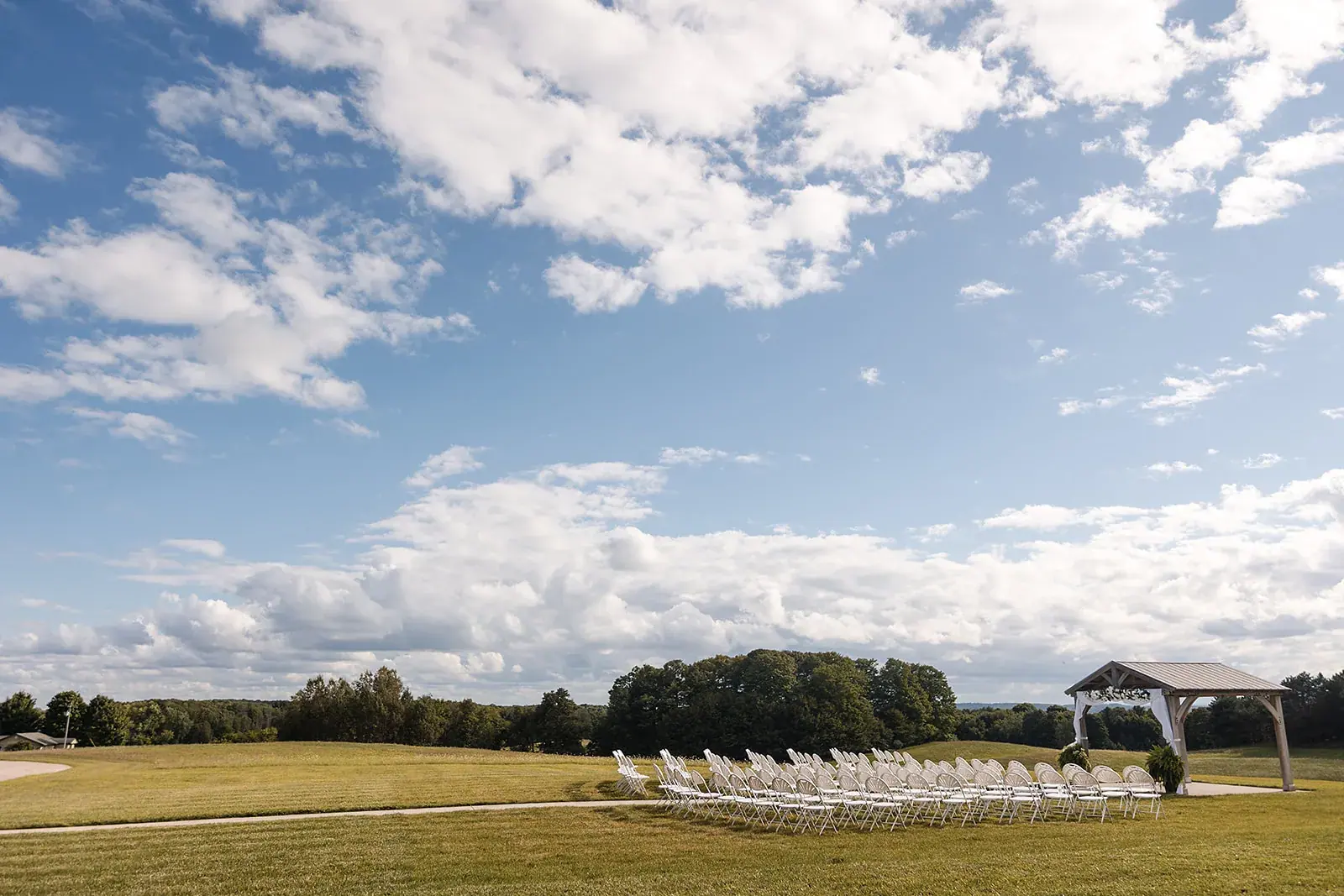 Ceremony site field wide — Amelia & Howard's wedding at Sunset Hill Wedding Barn, Central Lake