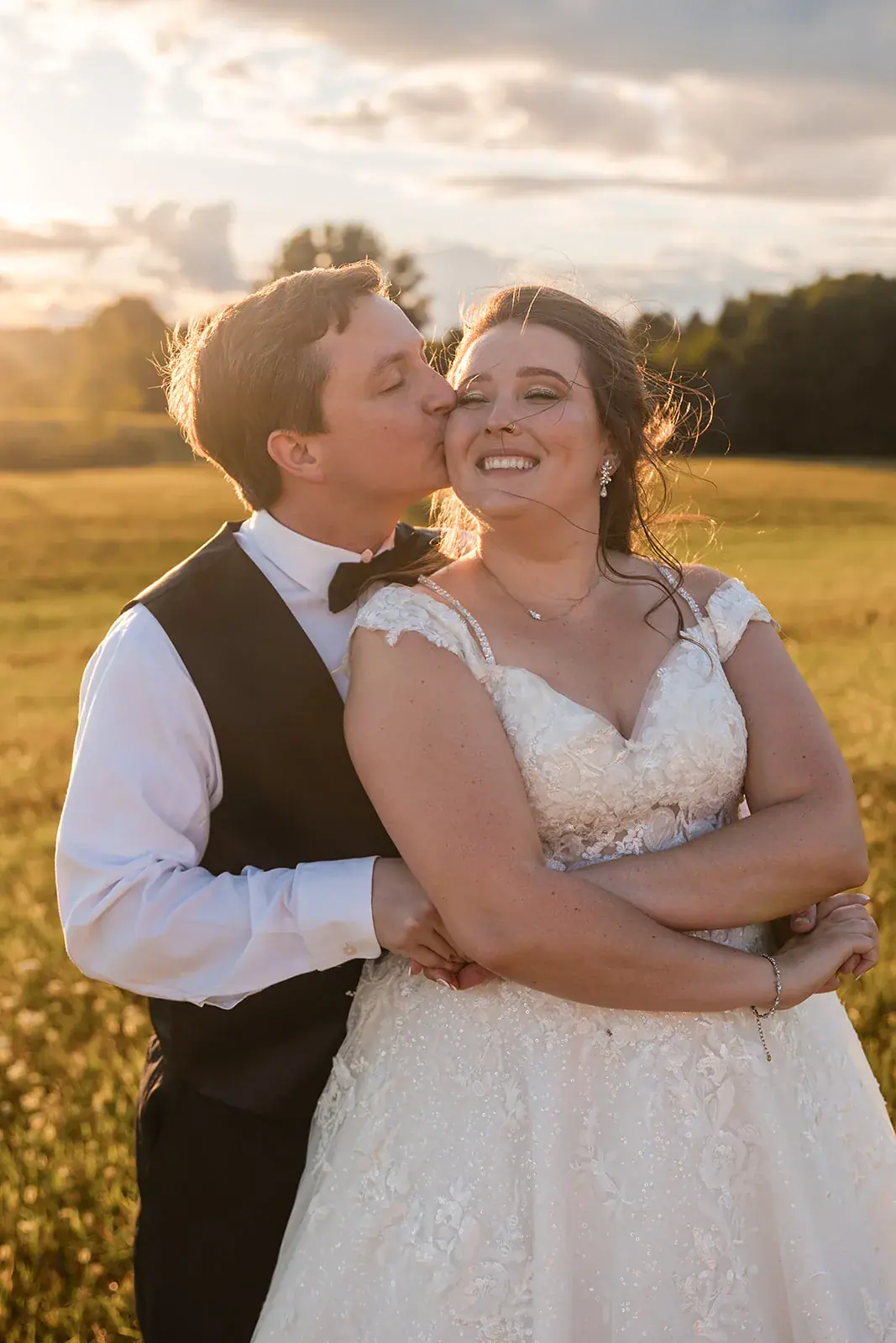 Groom kissing bride cheek golden hour — Amelia & Howard's wedding at Sunset Hill Wedding Barn, Central Lake
