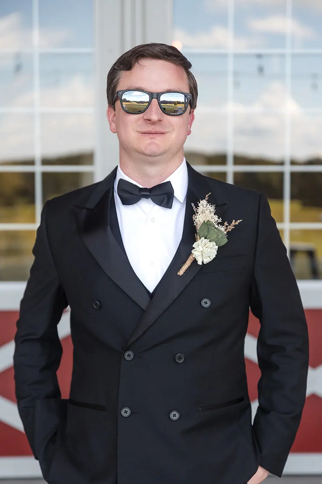 Groom tuxedo sunglasses red barn — Amelia & Howard's wedding at Sunset Hill Wedding Barn, Central Lake