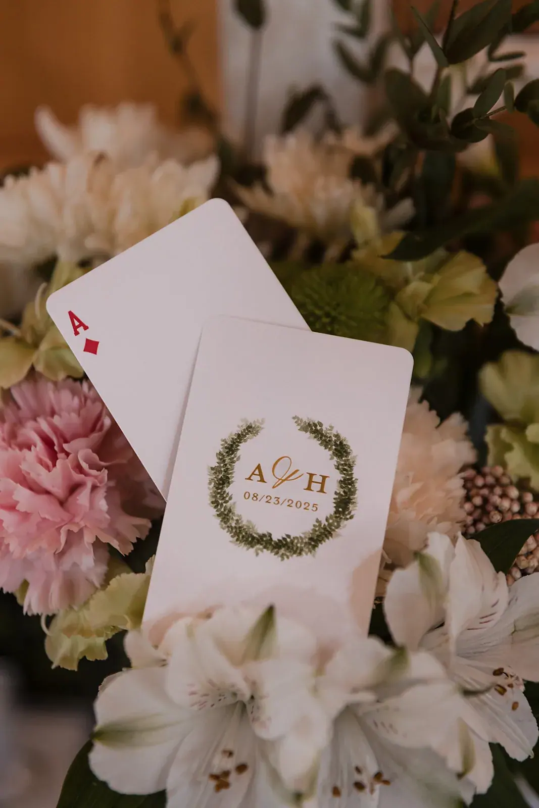 Invitation playing card bouquet detail — Amelia & Howard's wedding at Sunset Hill Wedding Barn, Central Lake