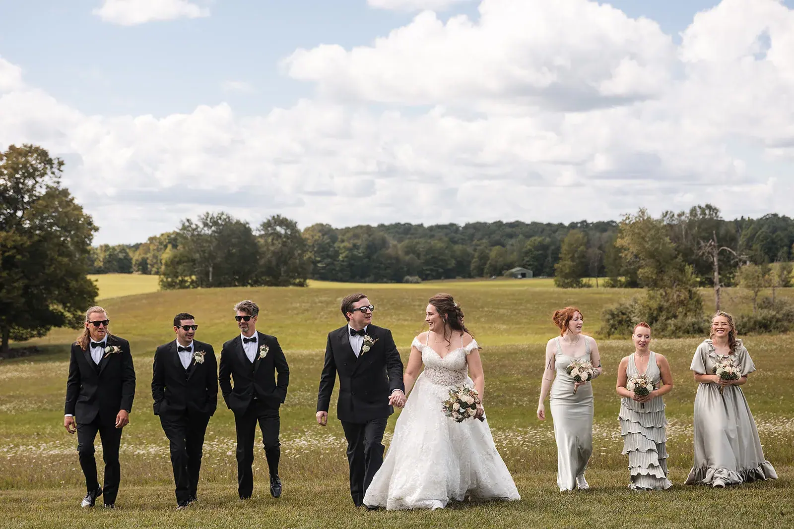 Wedding party walking field — Amelia & Howard's wedding at Sunset Hill Wedding Barn, Central Lake