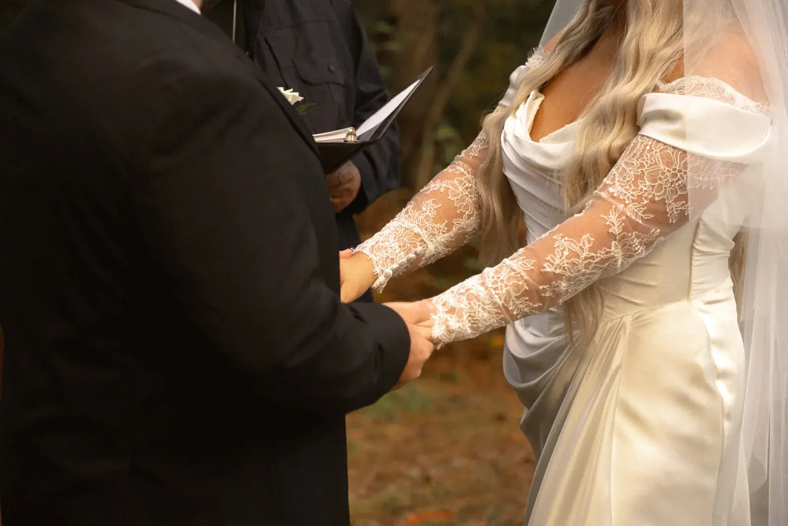Vows holding hands — Ann & Brad's wedding at their log home in Vanderbilt