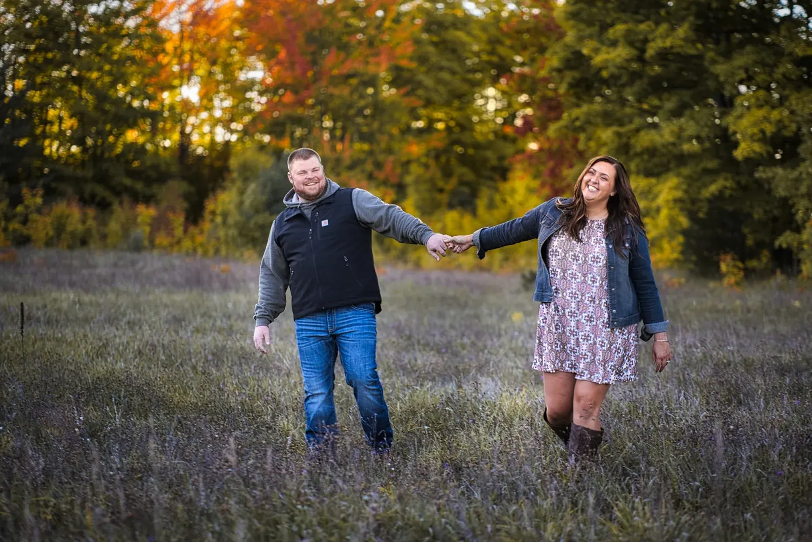 Couple holding hands wildflower meadow — Chelsea & Jake's engagement session at Aspen Park, Gaylord