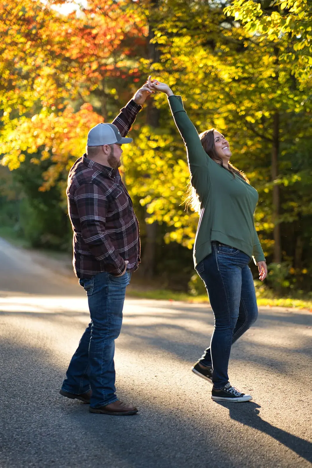 Groom twirling fiancee fall road — Chelsea & Jake's engagement session at Aspen Park, Gaylord