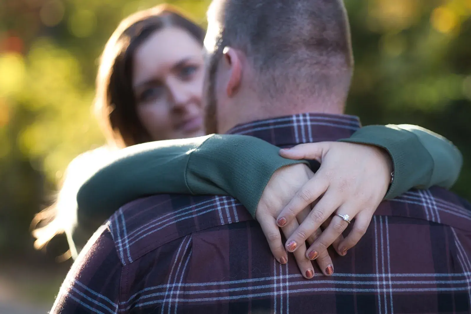 Hug engagement ring golden light — Chelsea & Jake's engagement session at Aspen Park, Gaylord