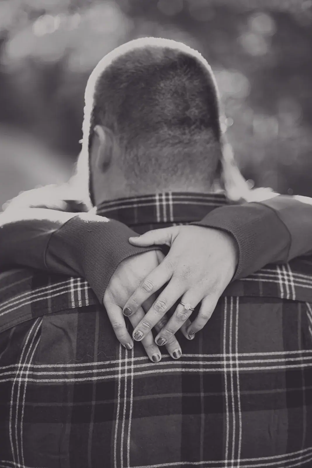 Hug from behind engagement ring in black and white — Chelsea & Jake's engagement session at Aspen Park, Gaylord