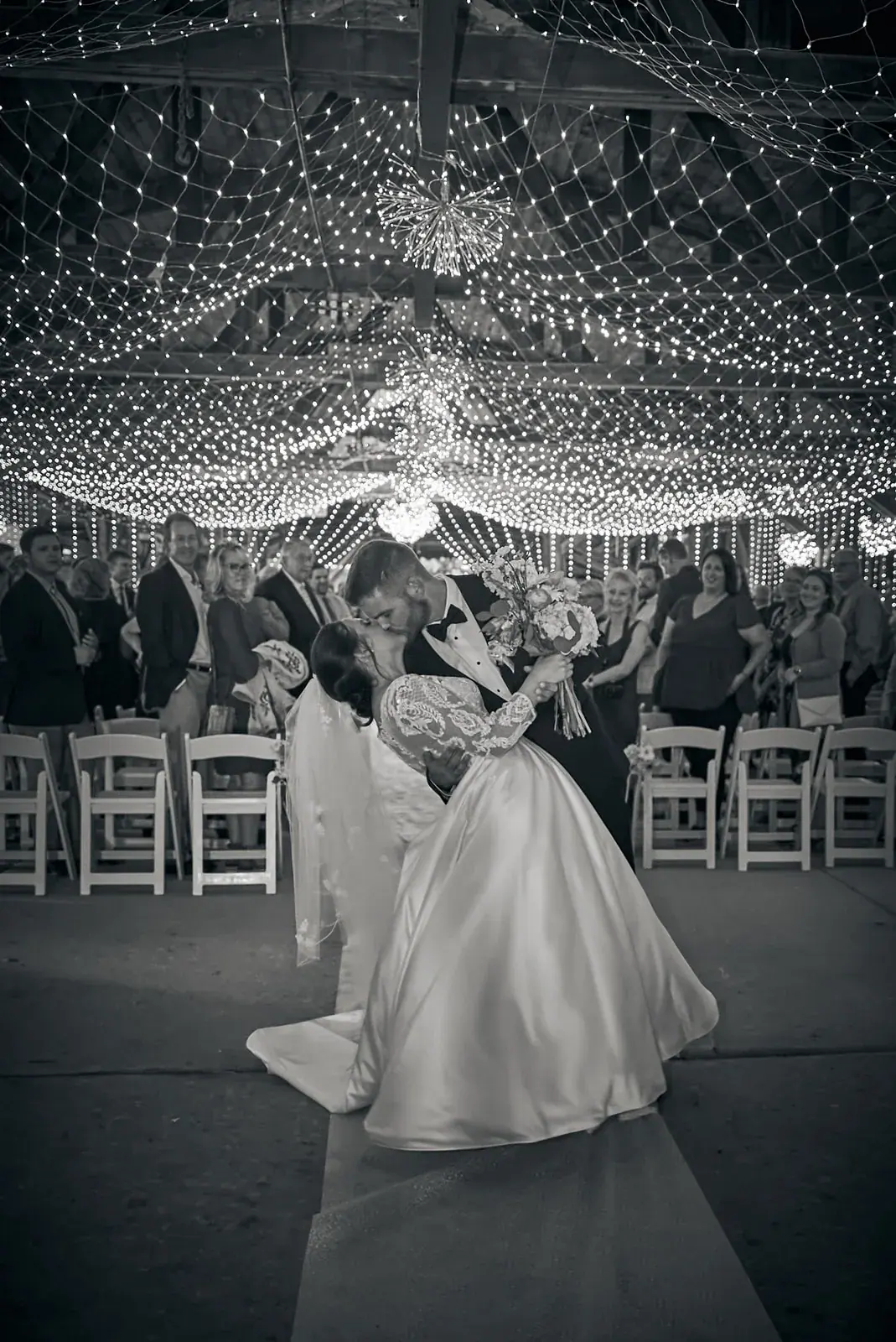 Boathouse ceremony string lights in black and white — Claire & Nick's wedding at Howe Marine, Indian River