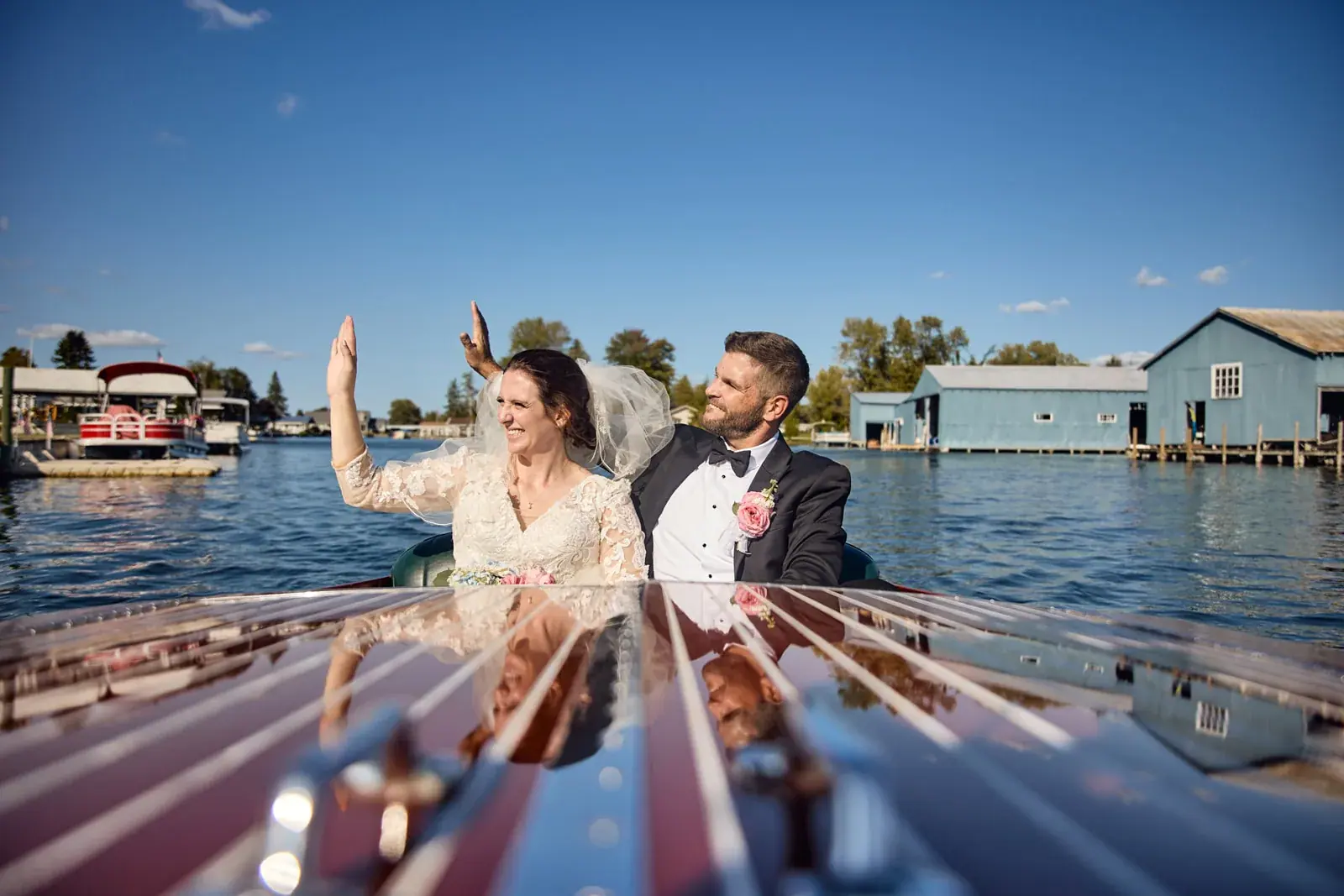 Bride and groom antique boat cheering — Claire & Nick's wedding at Howe Marine, Indian River