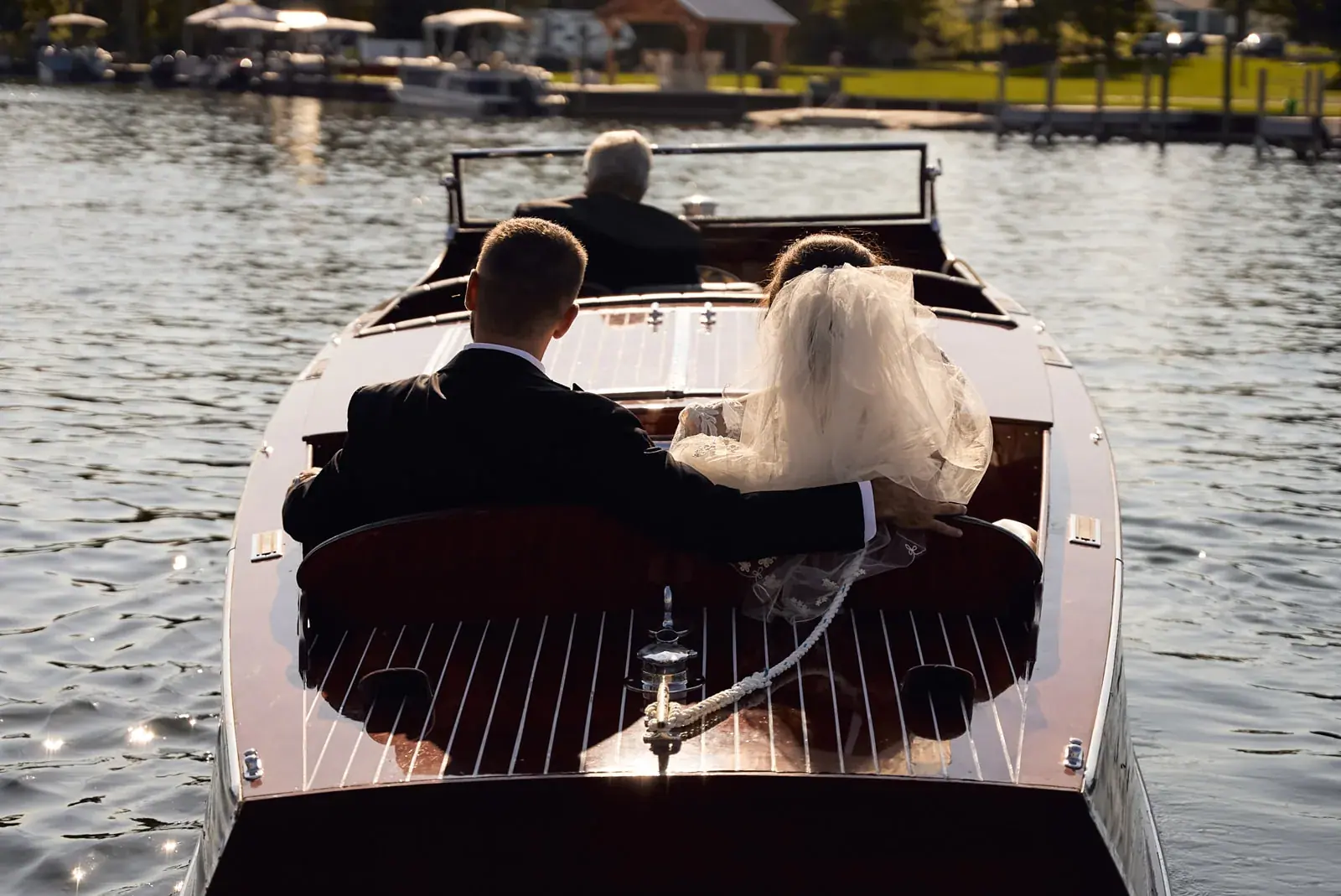 Bride and groom antique boat ride — Claire & Nick's wedding at Howe Marine, Indian River