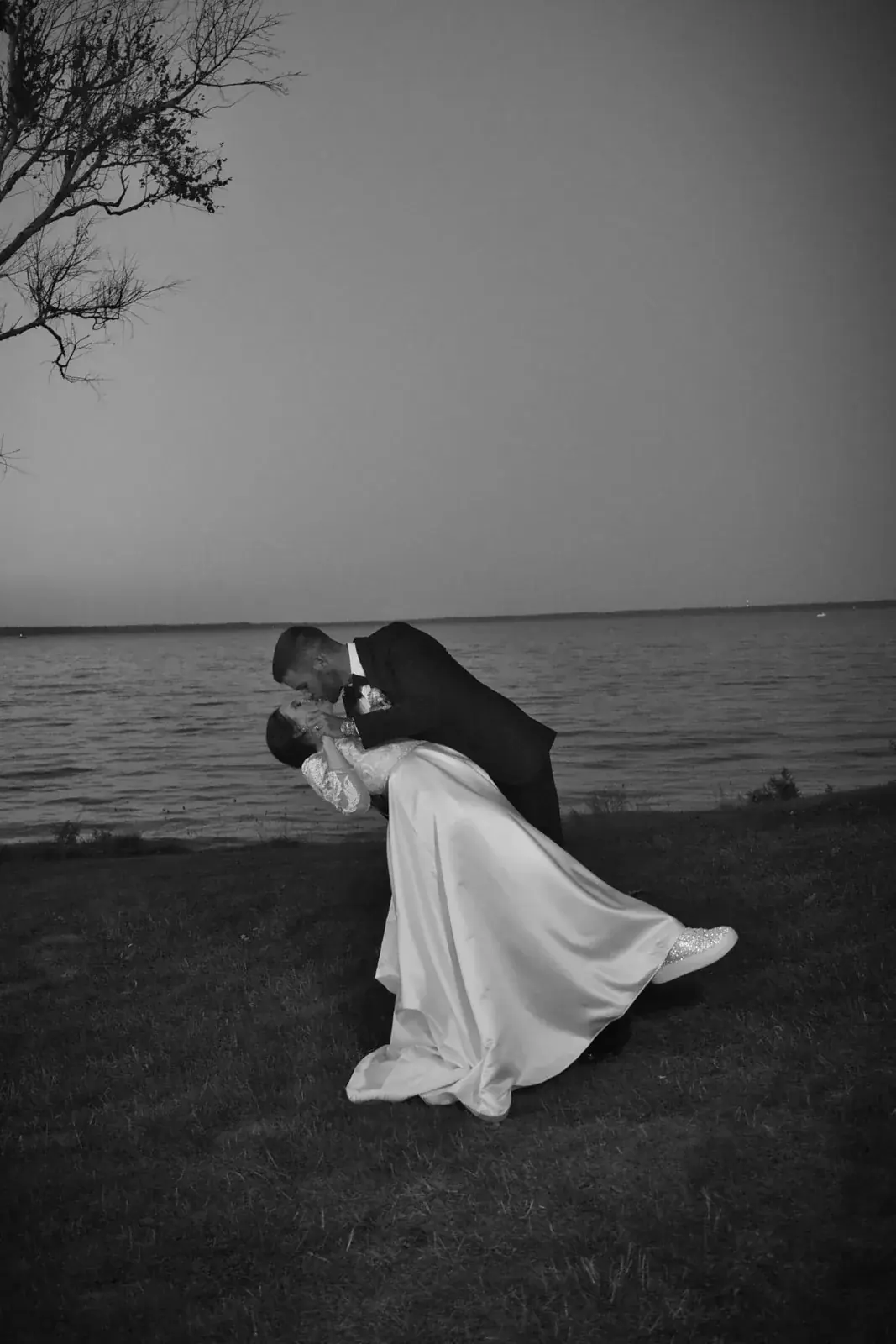 Bride and groom dip lake in black and white — Claire & Nick's wedding at Howe Marine, Indian River