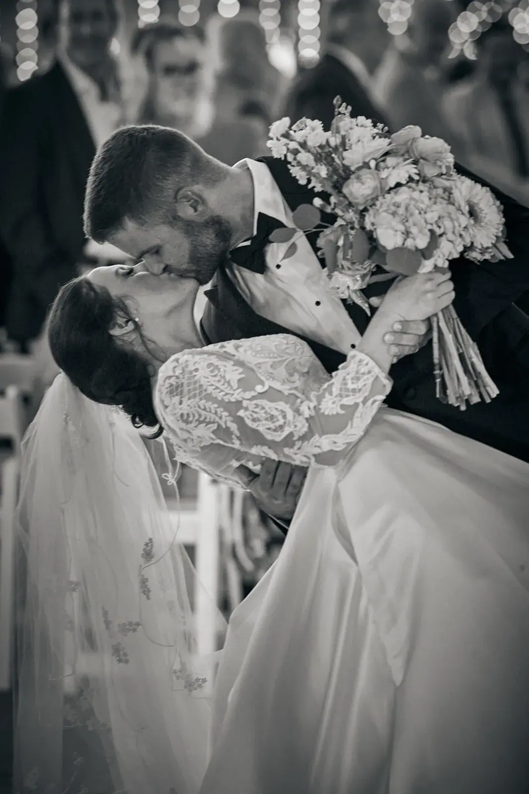 Bride and groom kiss bouquet in black and white — Claire & Nick's wedding at Howe Marine, Indian River