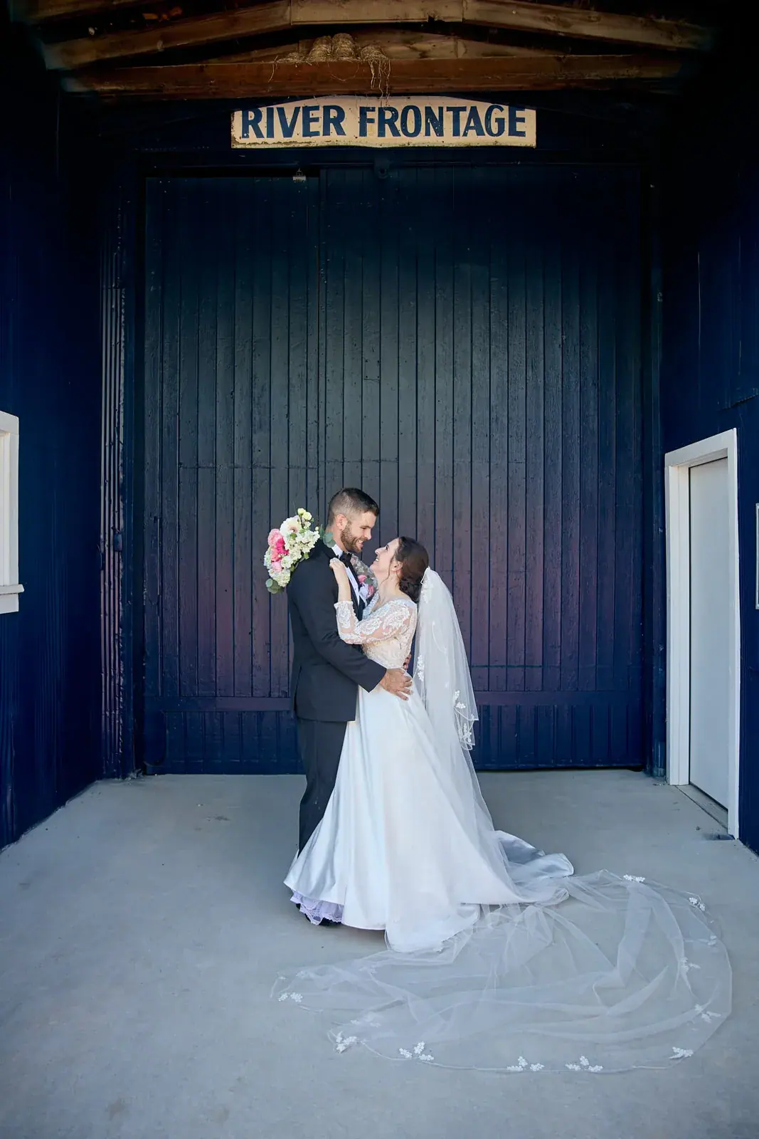 Bride and groom river frontage door — Claire & Nick's wedding at Howe Marine, Indian River