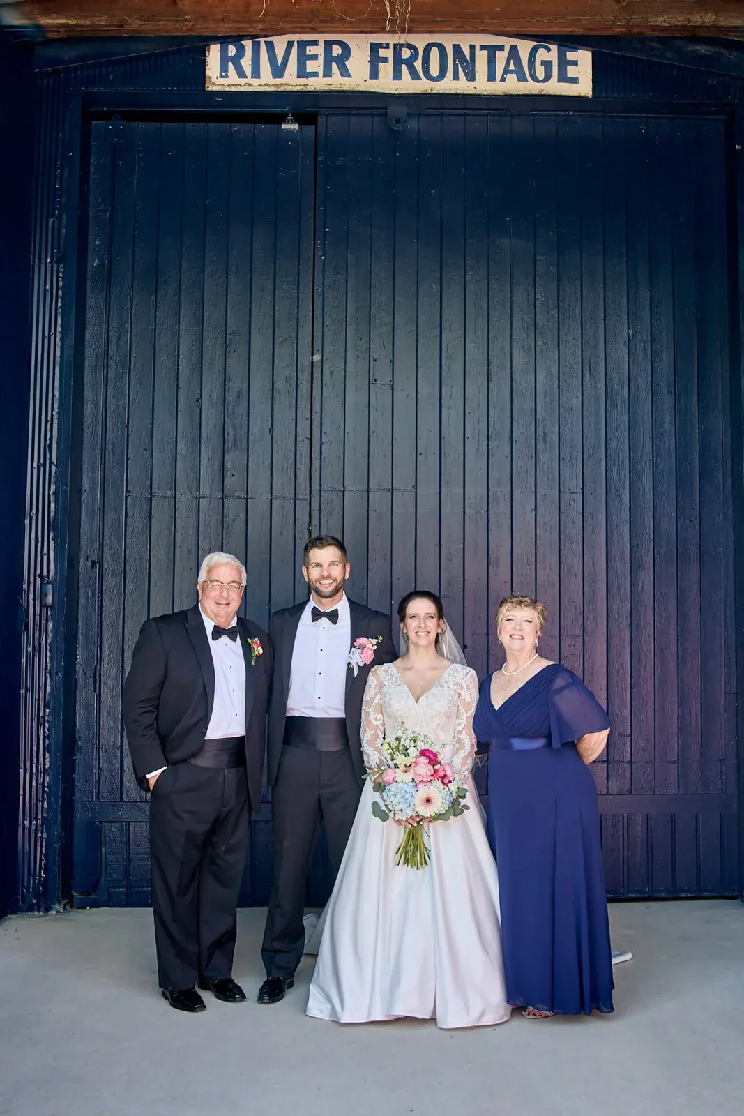 Families river frontage door — Claire & Nick's wedding at Howe Marine, Indian River