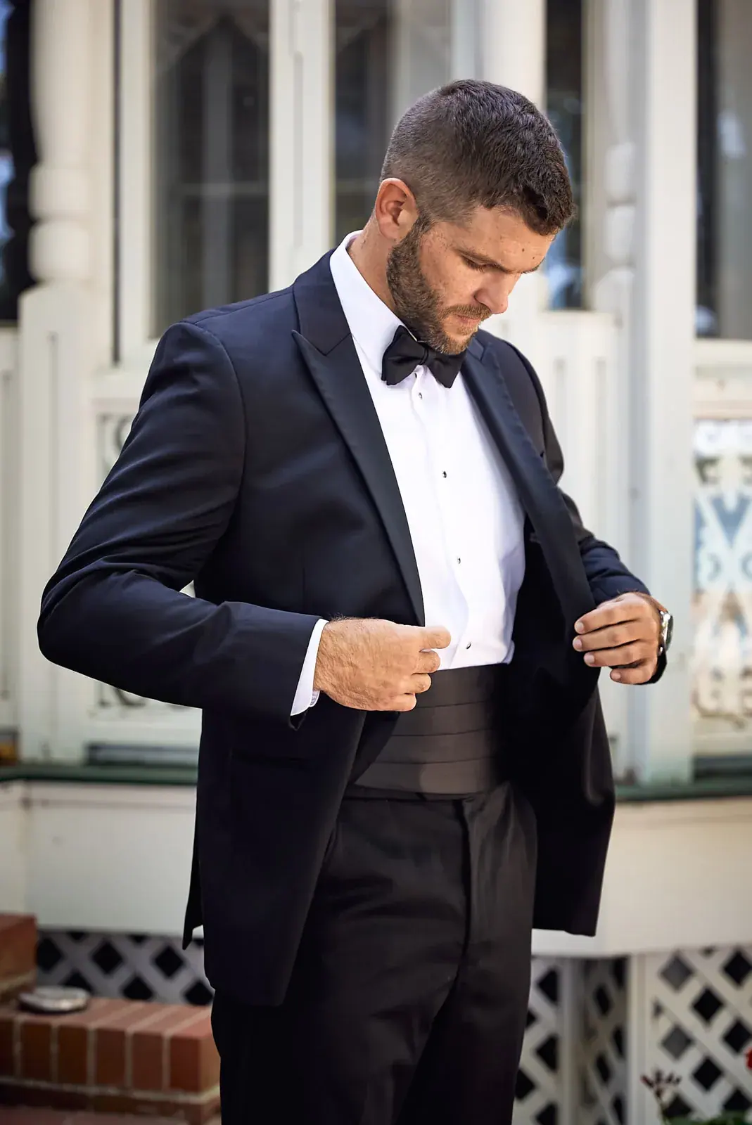 Groom buttoning jacket — Claire & Nick's wedding at Howe Marine, Indian River