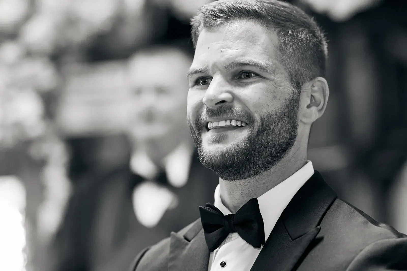 Groom laughing in black and white — Claire & Nick's wedding at Howe Marine, Indian River