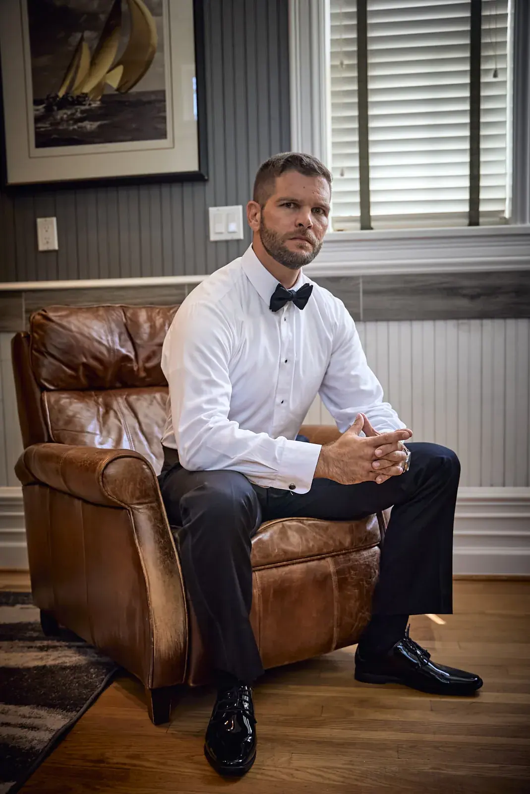 Groom leather chair portrait — Claire & Nick's wedding at Howe Marine, Indian River