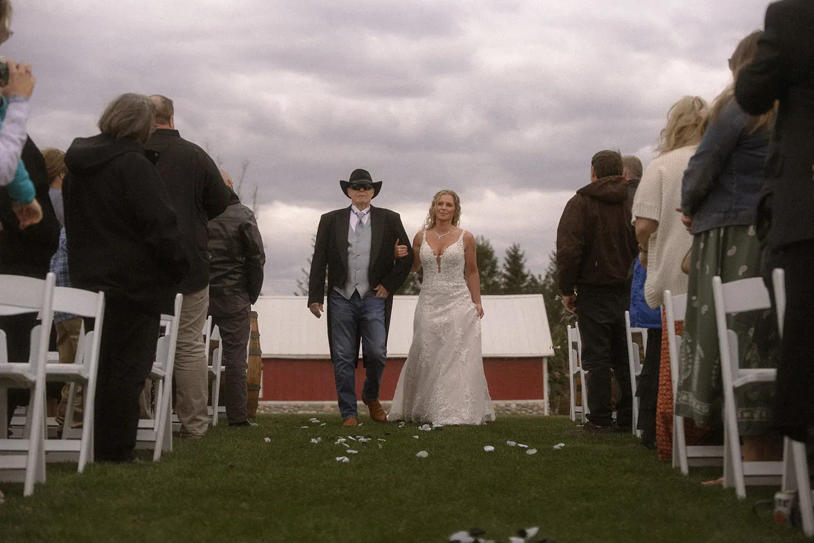Bride processional red barn — Erin & Jim's wedding at Sonshine Barn, Gaylord