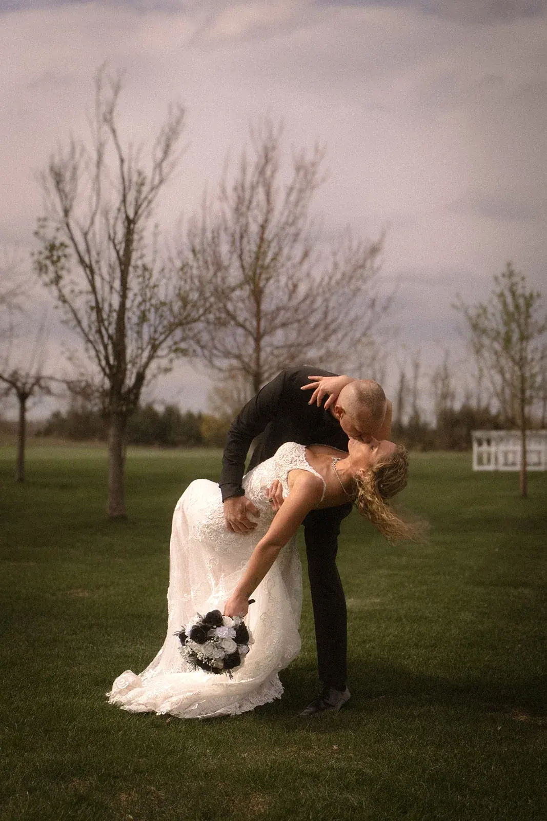 Groom dipping bride trees — Erin & Jim's wedding at Sonshine Barn, Gaylord