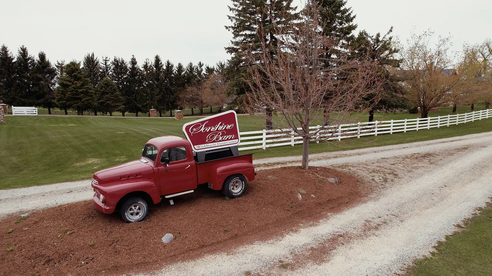Vintage red truck farm drive — Erin & Jim's wedding at Sonshine Barn, Gaylord