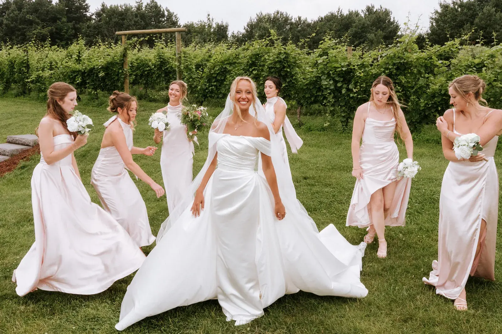 Bride bridesmaids walking vineyard — Heather & Evan's wedding at Black Star Farms
