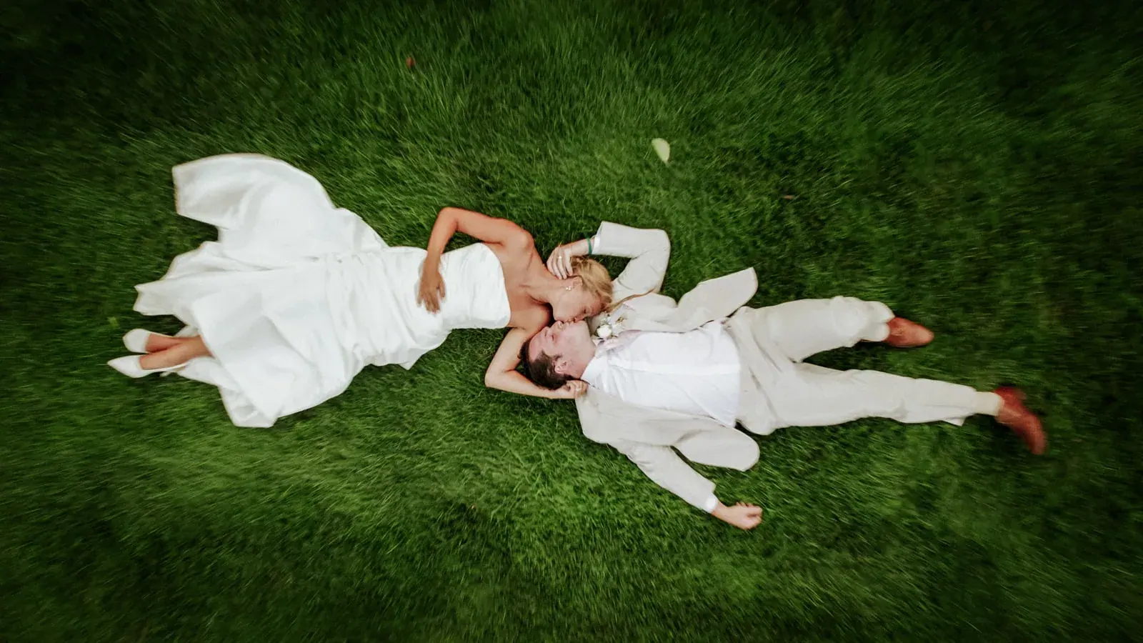 Bride and groom lying in grass aerial — Heather & Evan's wedding at Black Star Farms