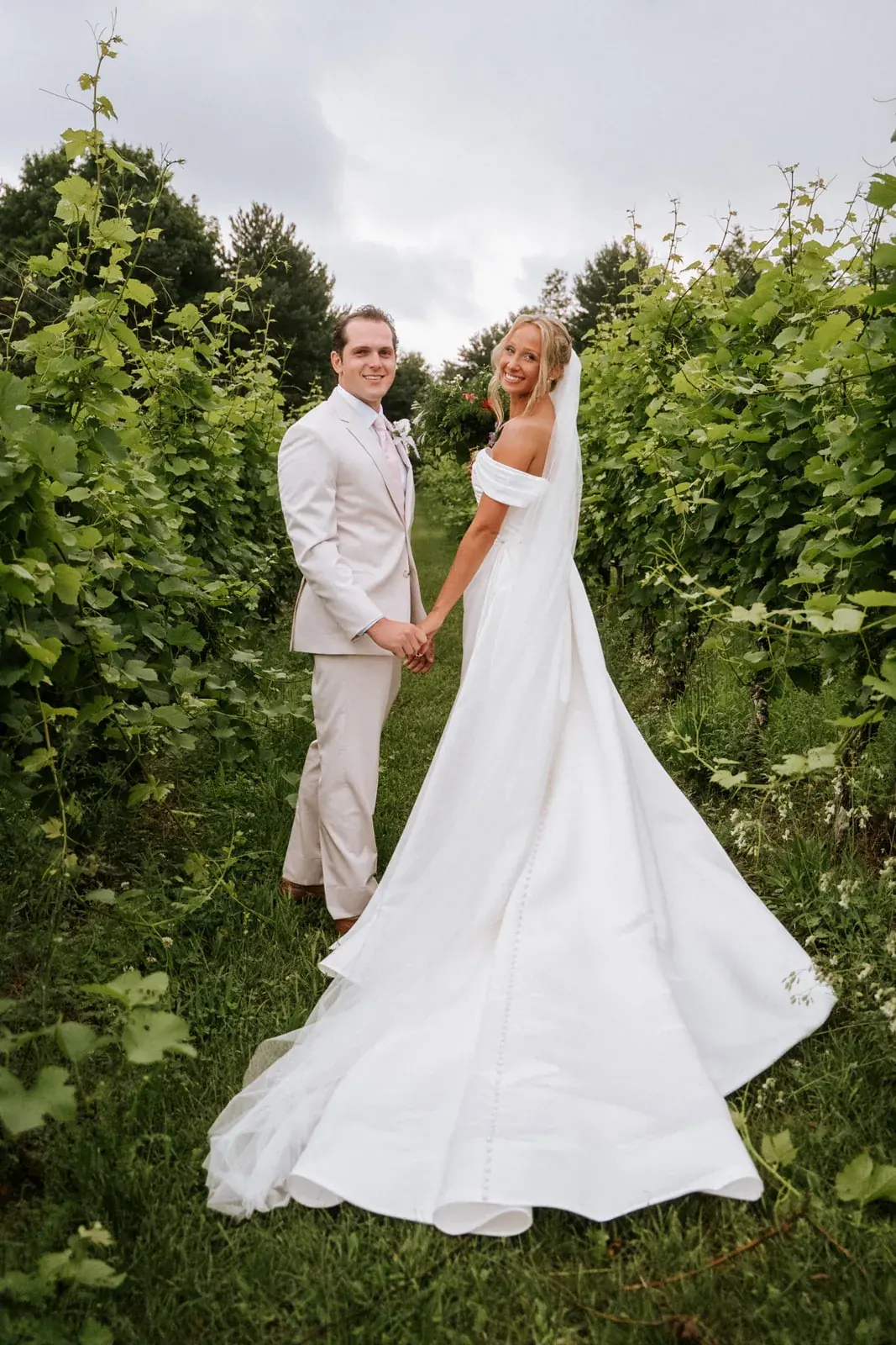 Bride and groom vineyard rows portrait — Heather & Evan's wedding at Black Star Farms