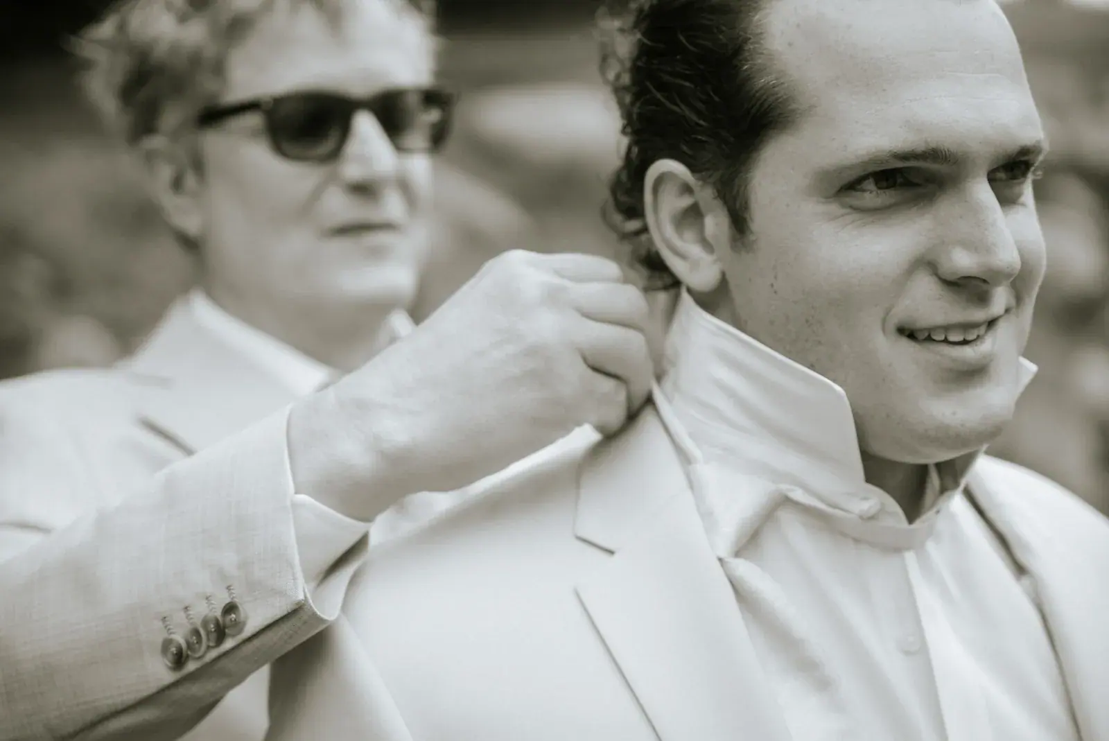Groom fixing collar in black and white — Heather & Evan's wedding at Black Star Farms