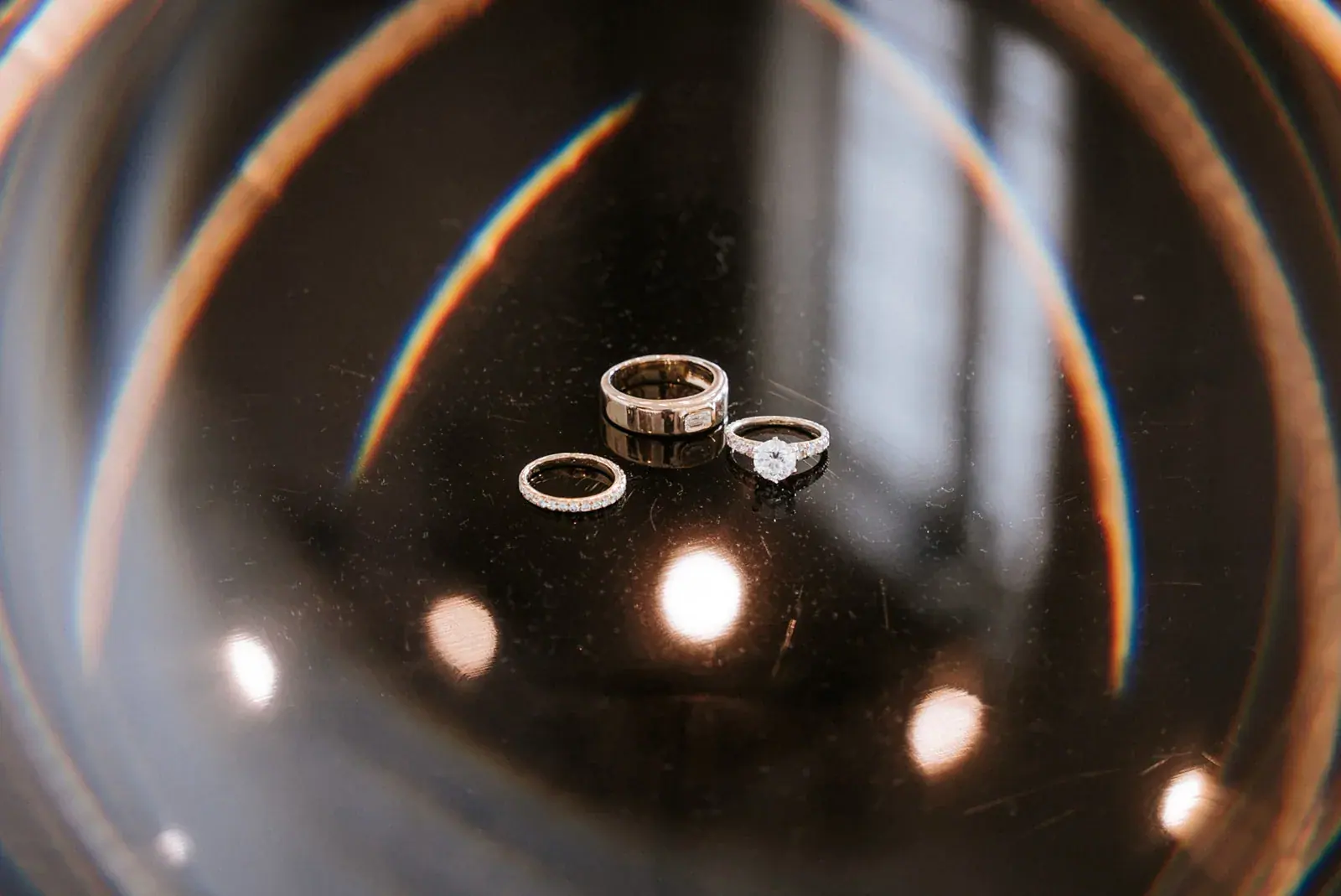 Wedding rings glass reflection — Heather & Evan's wedding at Black Star Farms