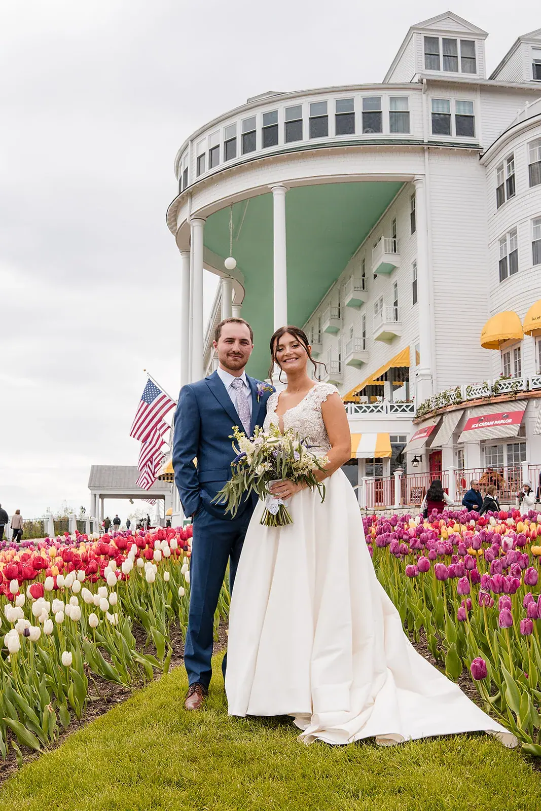 Bride and groom in the tulip gardens in front of the Grand Hotel on Mackinac Island