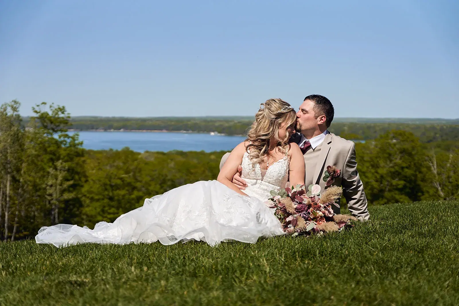 Bride and groom lying lake overlook — Jess & Bryce's wedding at The Manor at Fire Tower Hill, Lewiston