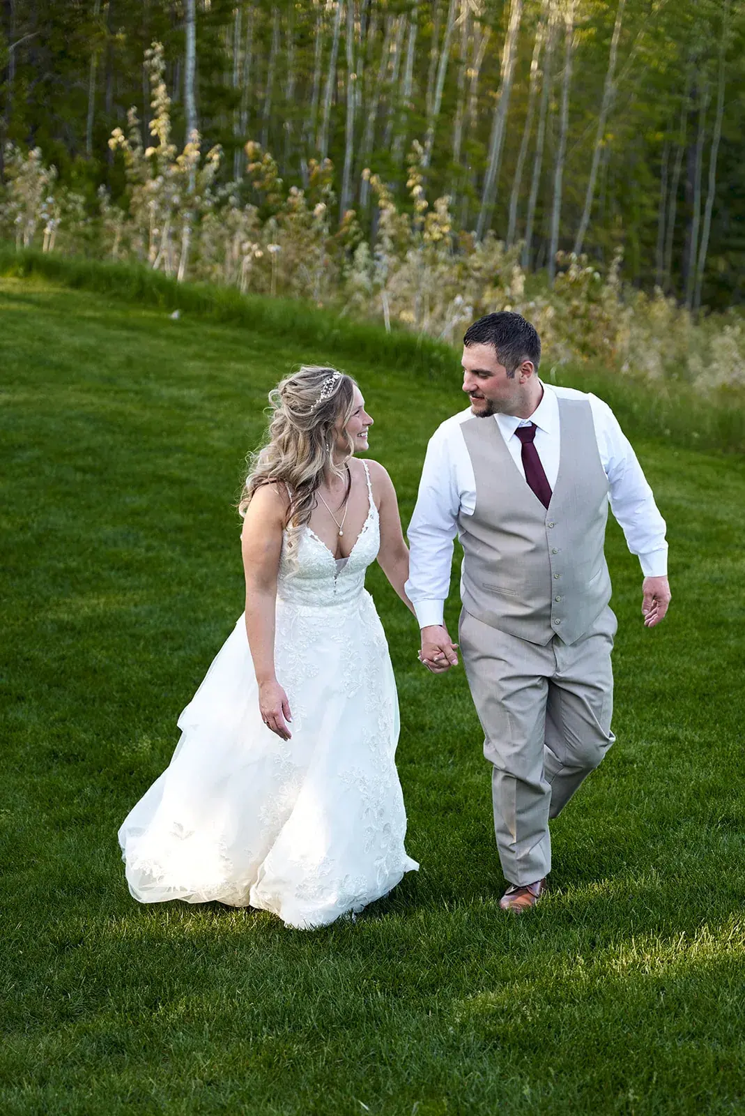 Bride and groom walking lawn woods — Jess & Bryce's wedding at The Manor at Fire Tower Hill, Lewiston