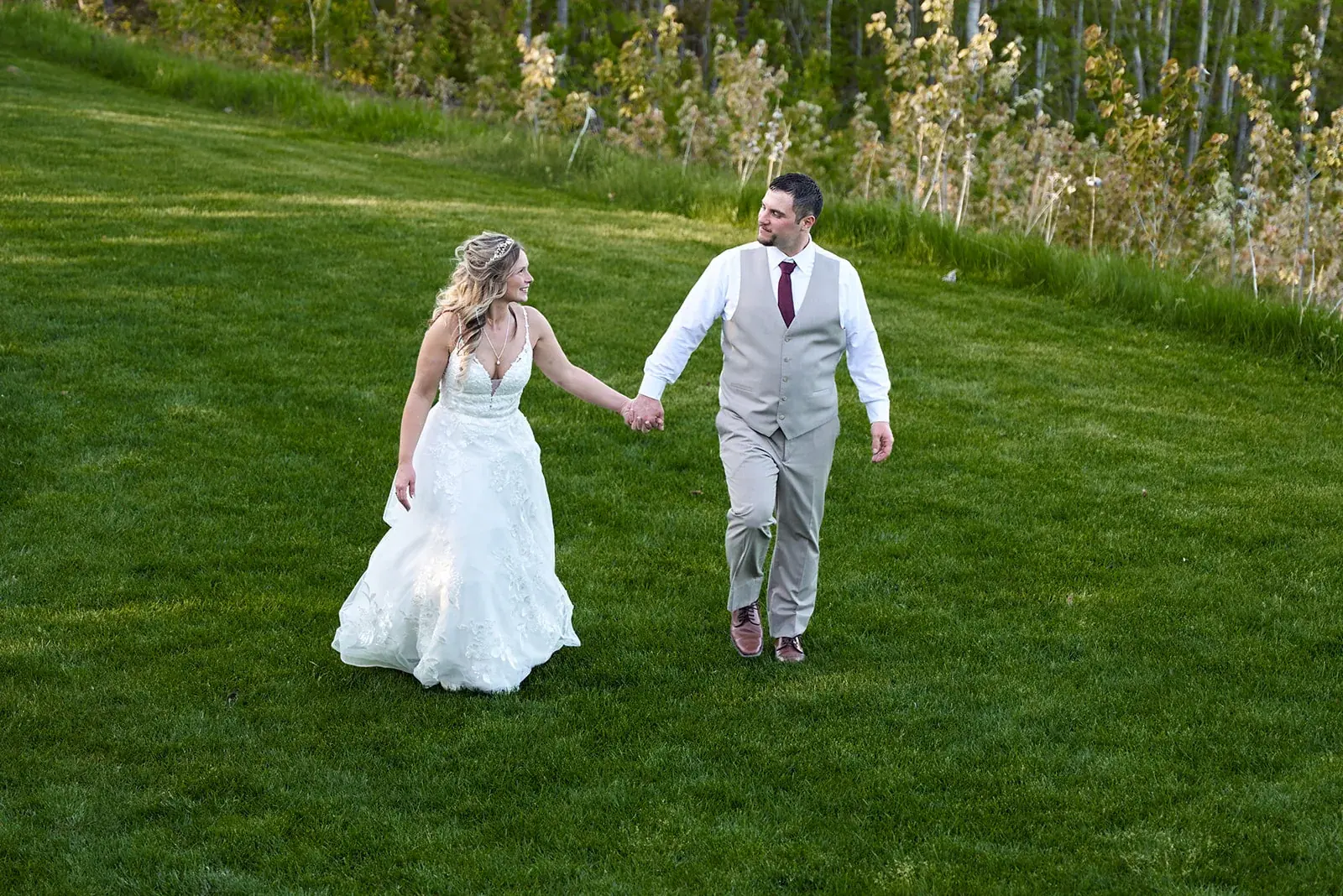 Bride and groom walking lawn — Jess & Bryce's wedding at The Manor at Fire Tower Hill, Lewiston