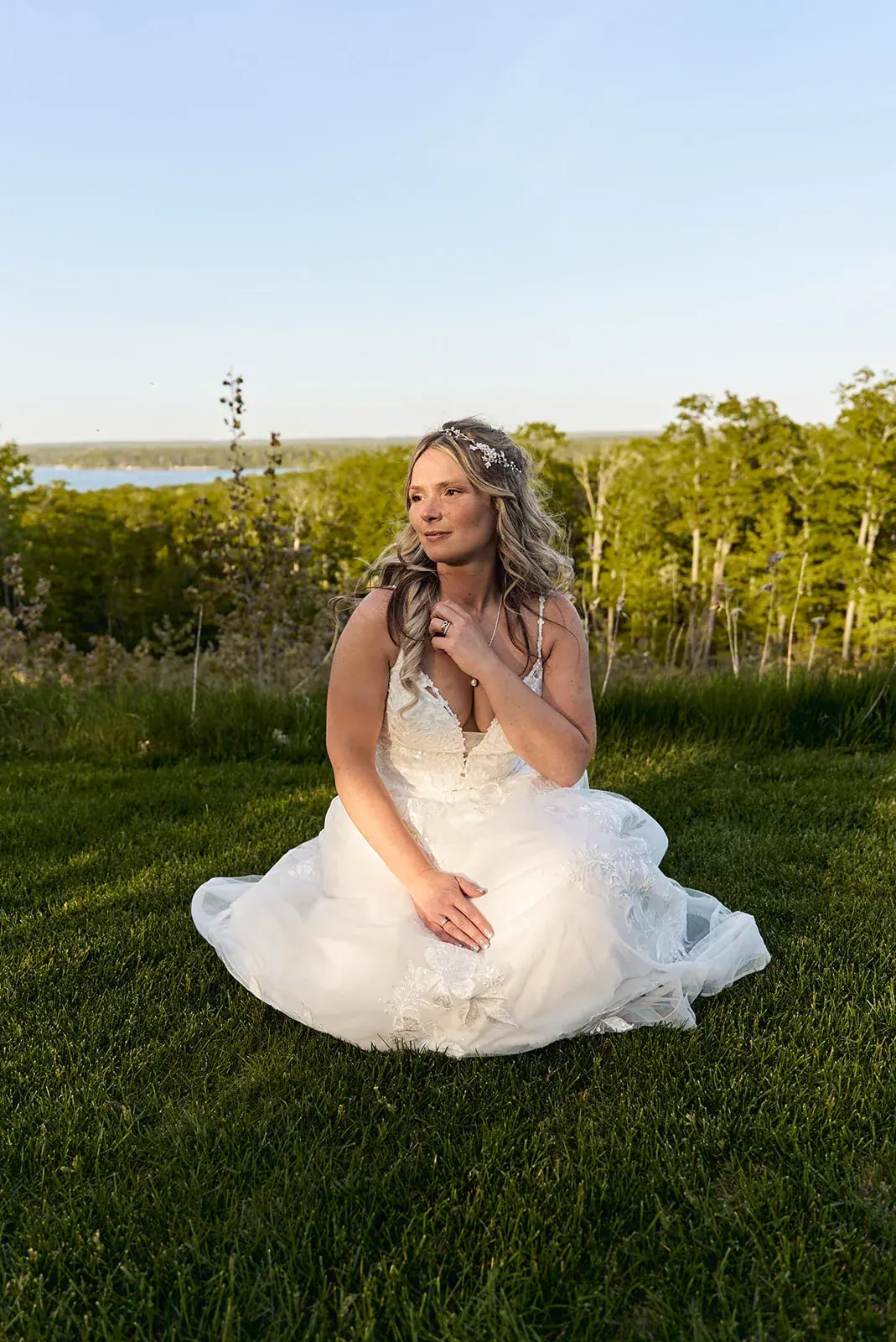 Bride sitting in grass — Jess & Bryce's wedding at The Manor at Fire Tower Hill, Lewiston