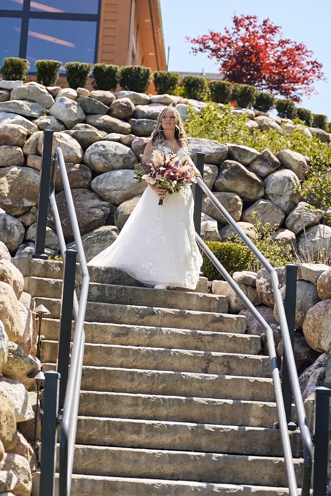 Bride walking down stone stairs — Jess & Bryce's wedding at The Manor at Fire Tower Hill, Lewiston