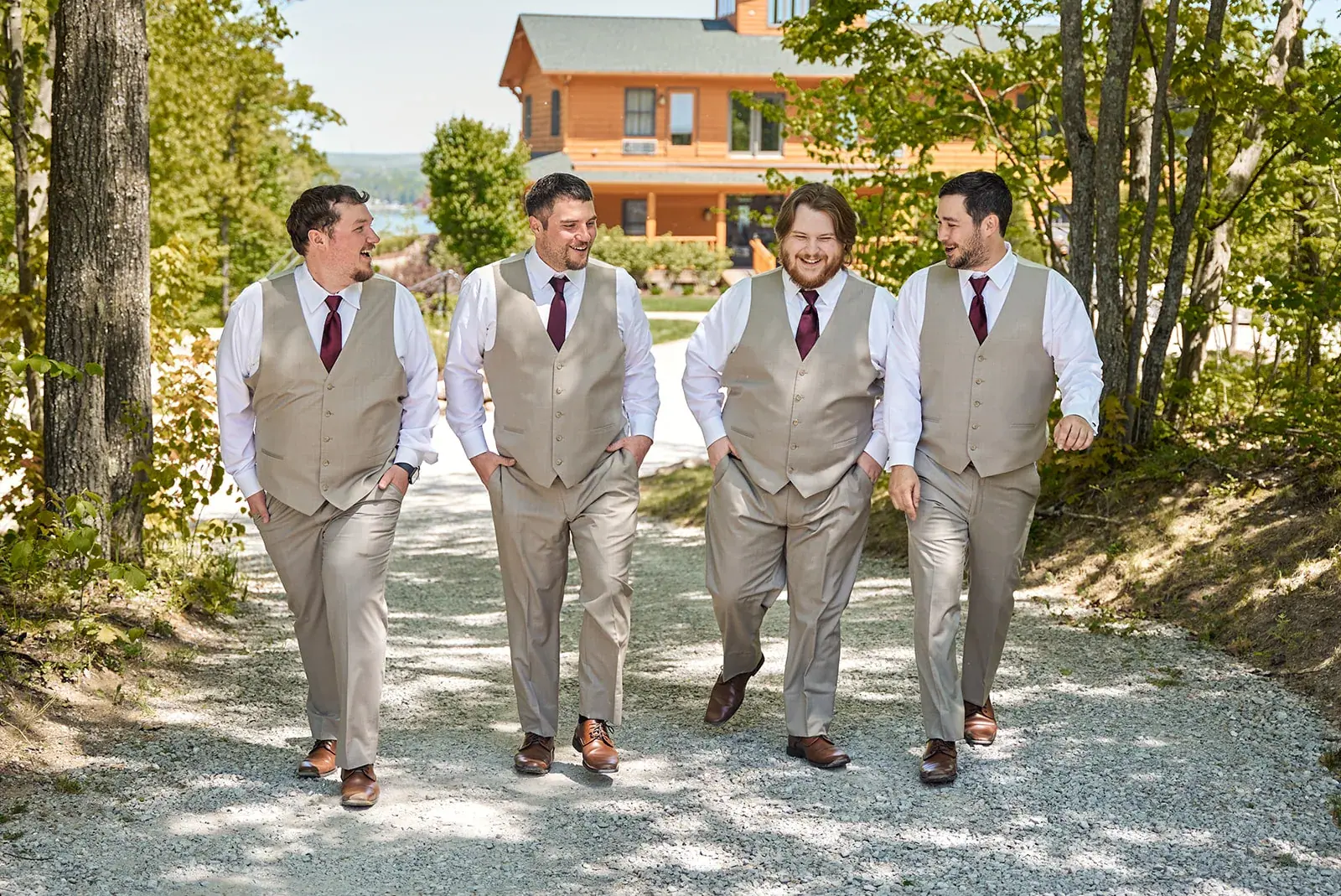 Groomsmen walking lodge path — Jess & Bryce's wedding at The Manor at Fire Tower Hill, Lewiston