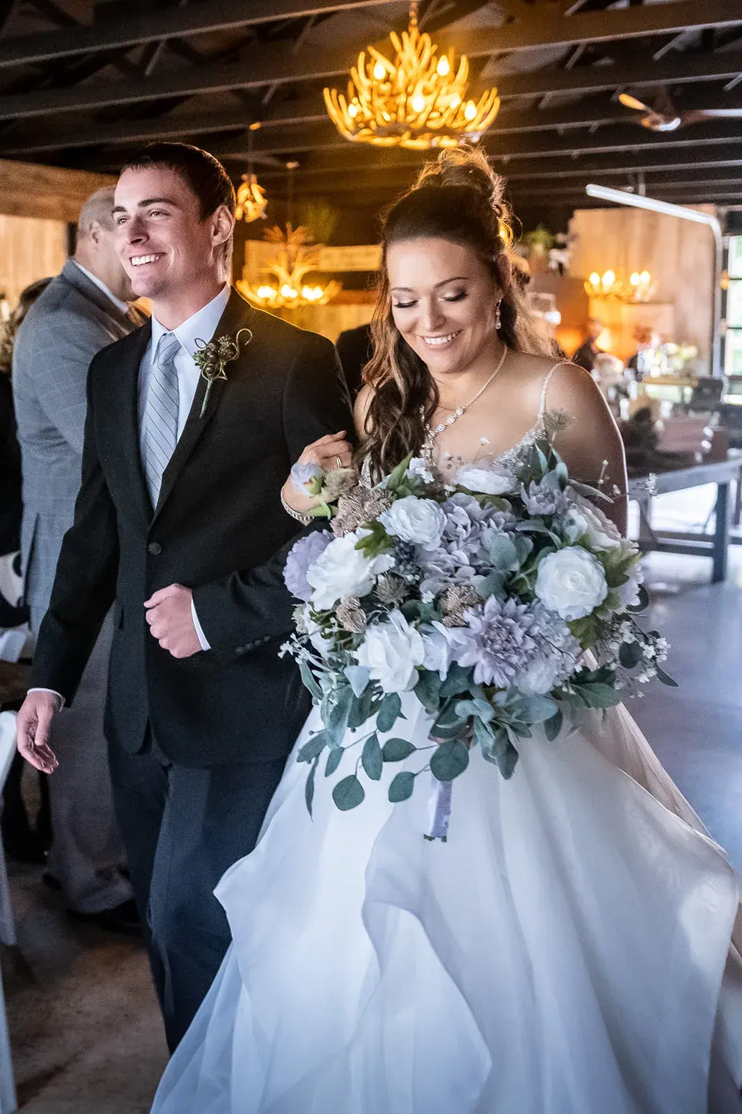 Bride and groom barn entrance chandelier — Jessica & Joel's wedding at The Rut Hutt, Gaylord