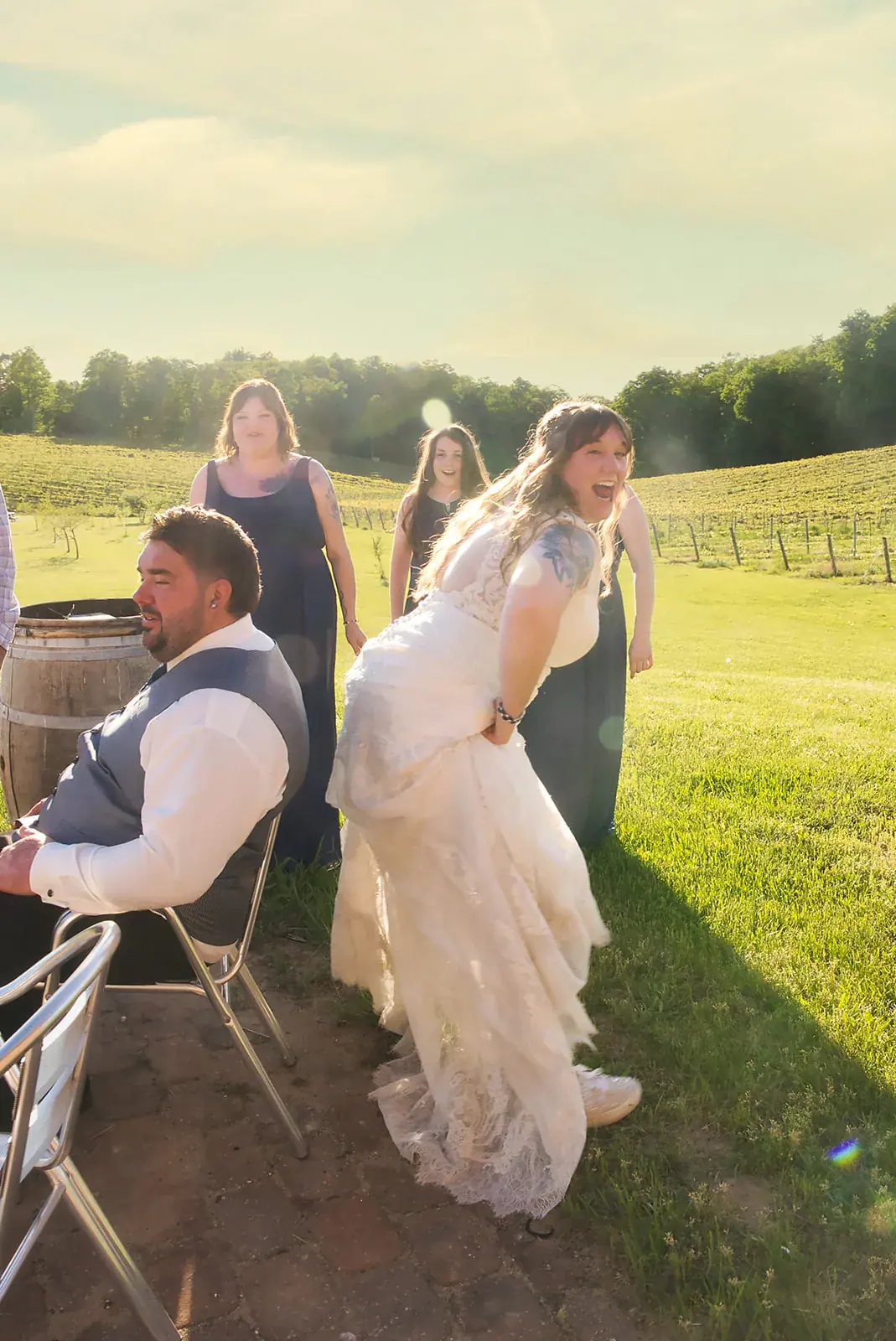 Bride bridesmaids candid — Kayla & Robert's wedding at Mackinaw Trail Winery, Petoskey