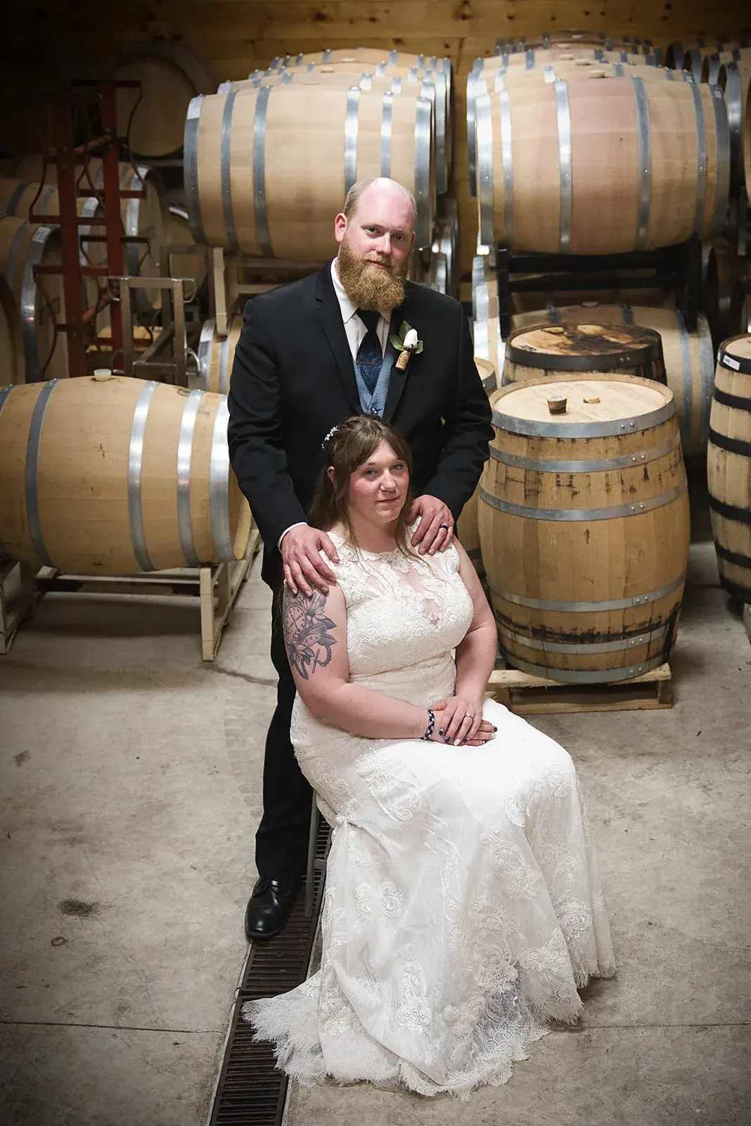 Bride and groom barrel room portrait — Kayla & Robert's wedding at Mackinaw Trail Winery, Petoskey