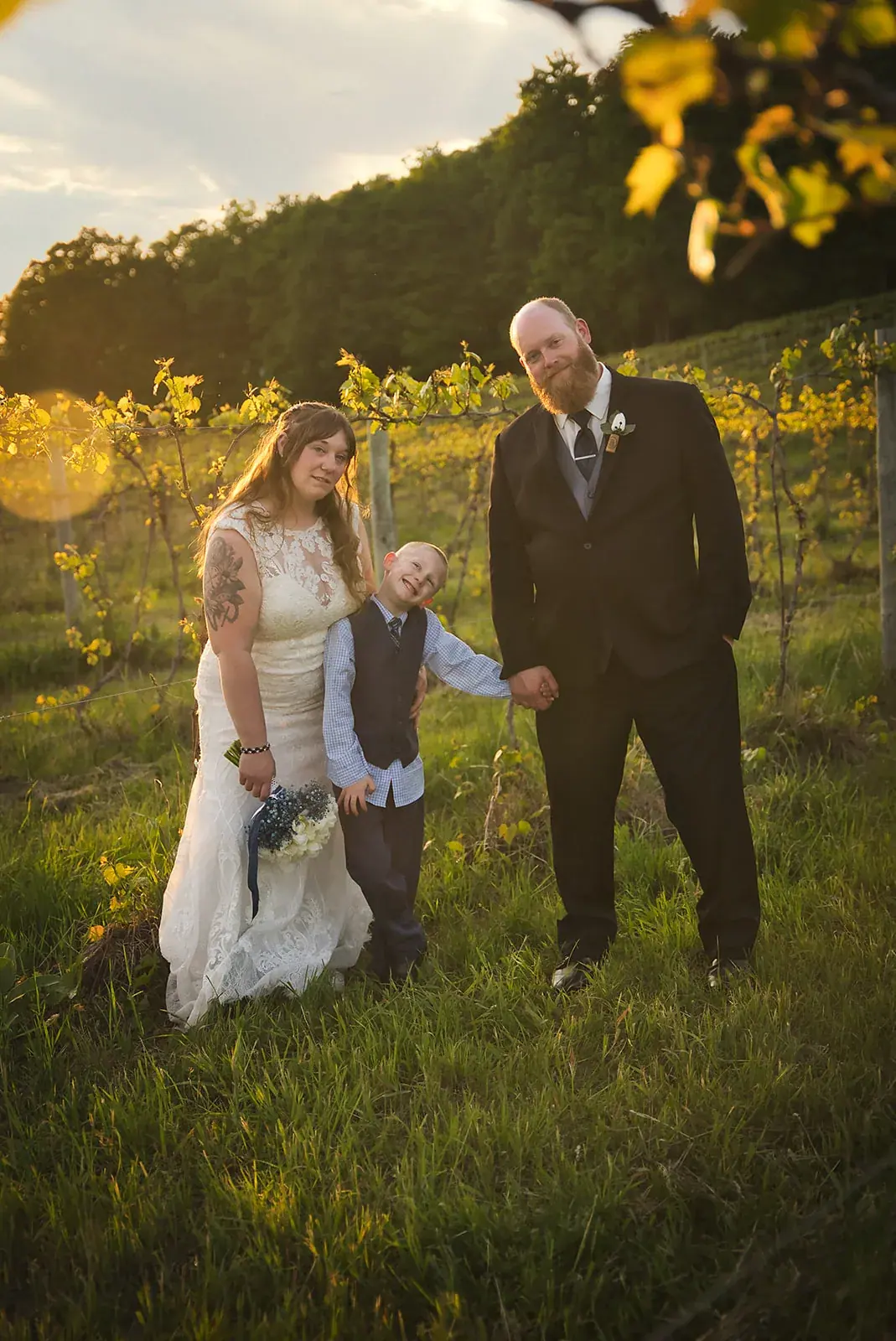 Bride and groom son vineyard rows — Kayla & Robert's wedding at Mackinaw Trail Winery, Petoskey
