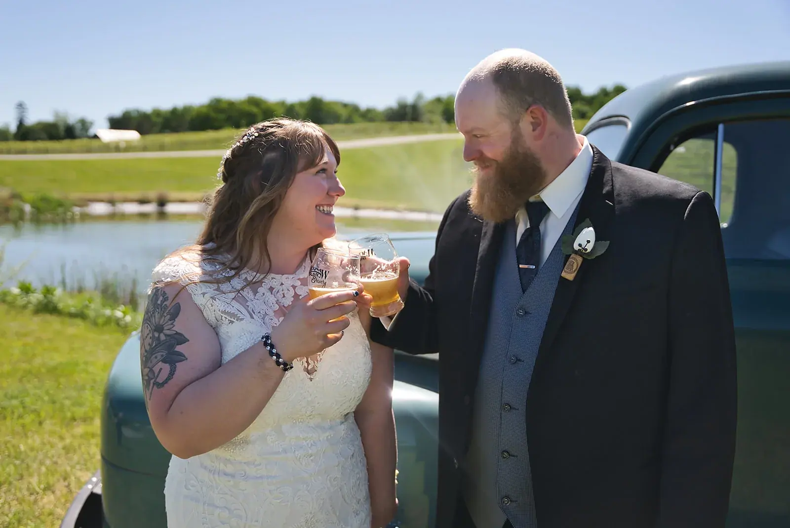 Bride and groom truck laughing — Kayla & Robert's wedding at Mackinaw Trail Winery, Petoskey