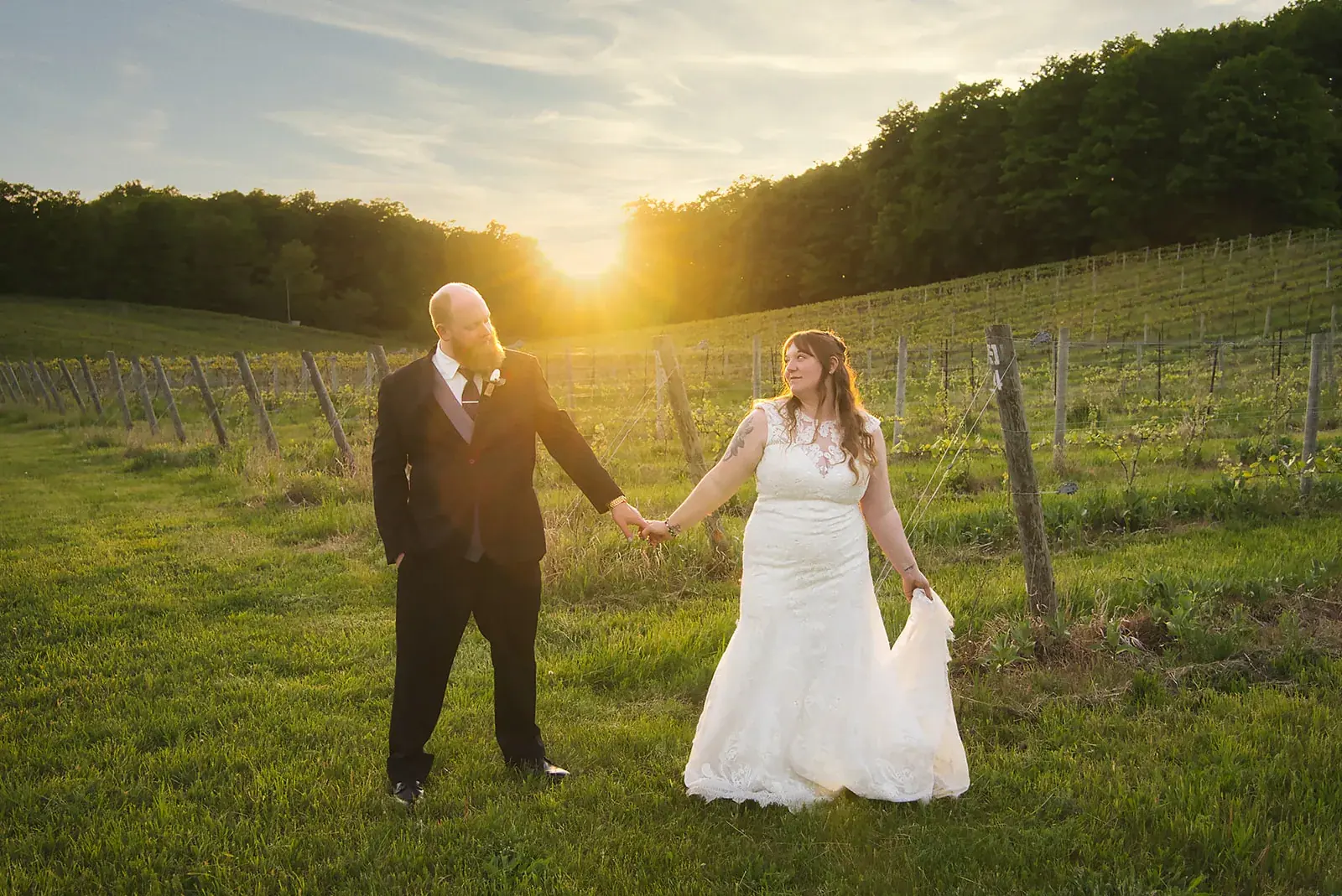Bride and groom vineyard sunset — Kayla & Robert's wedding at Mackinaw Trail Winery, Petoskey