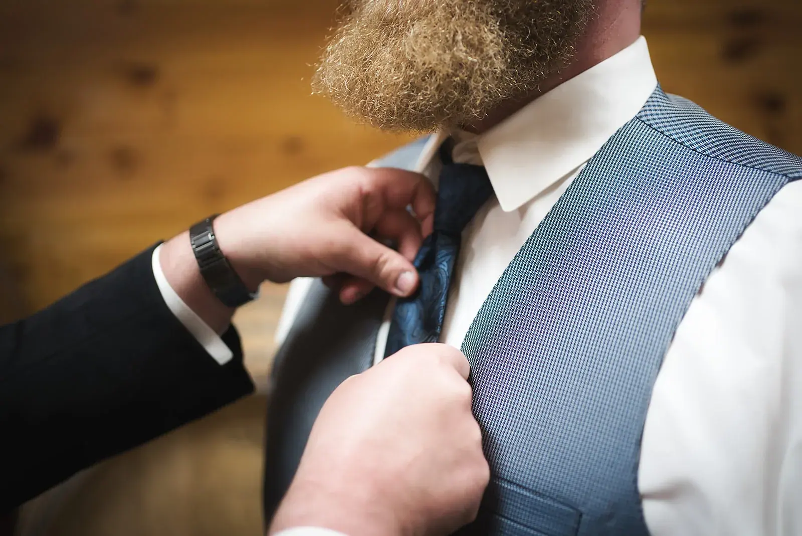 Groom adjusting tie — Kayla & Robert's wedding at Mackinaw Trail Winery, Petoskey