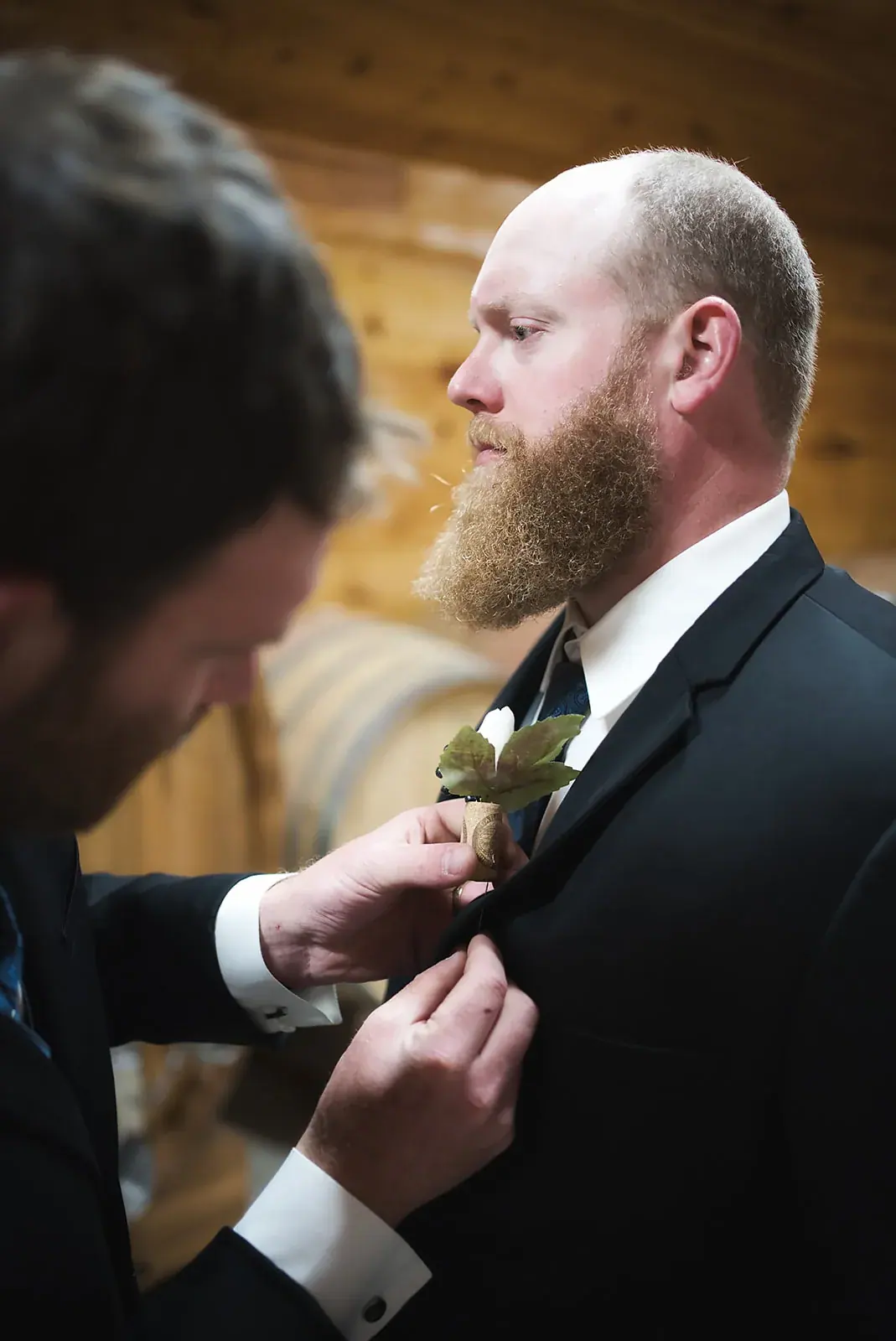 Groom boutonniere pinning — Kayla & Robert's wedding at Mackinaw Trail Winery, Petoskey