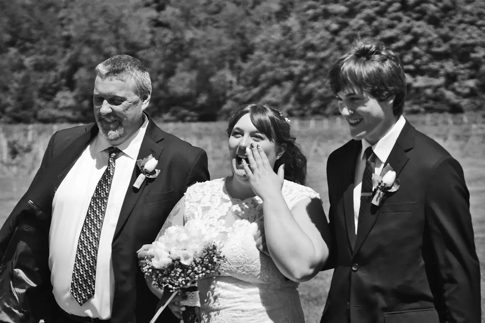 Groomsmen laughing in black and white — Kayla & Robert's wedding at Mackinaw Trail Winery, Petoskey