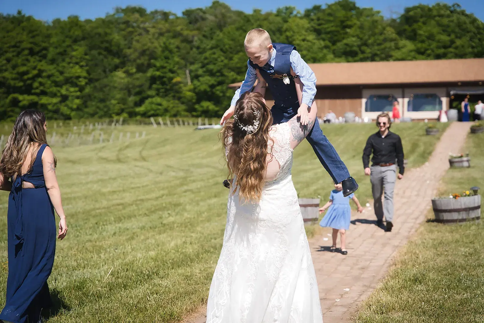 Ring bearer lifted celebration — Kayla & Robert's wedding at Mackinaw Trail Winery, Petoskey